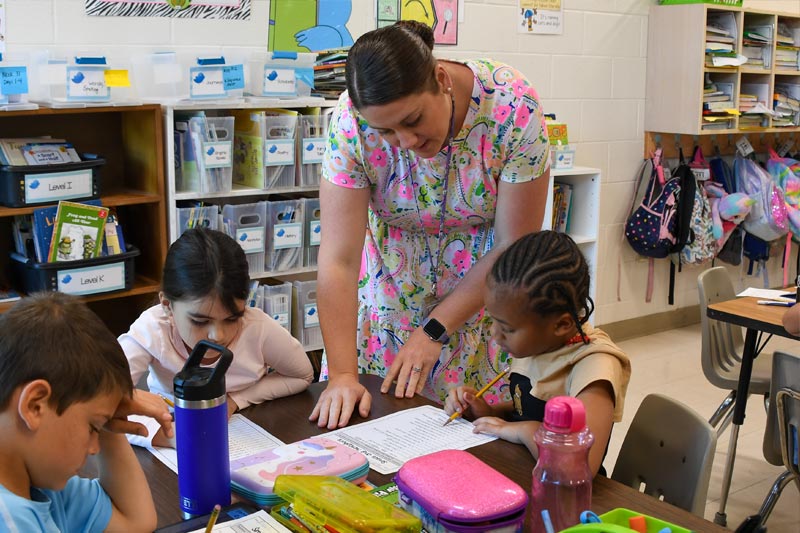 Female teacher with 3 students