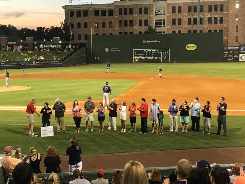 Dr. Burke Royster and school representatives were on hand at Monday’s Greenville Drive game as GE Power and 3D Systems donated 14 Cube 3 printers to Greenville County Schools. - photo of group show at Greenville Drive field