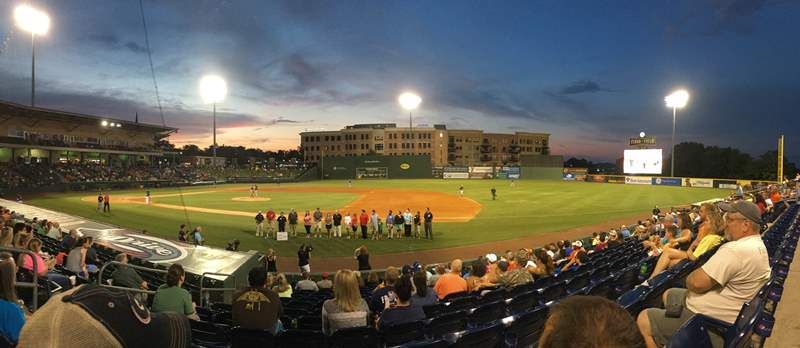 Dr. Burke Royster and school representatives were on hand at Monday’s Greenville Drive game as GE Power and 3D Systems donated 14 Cube 3 printers to Greenville County Schools - photo of distant show of presentation on Greenville Drive field