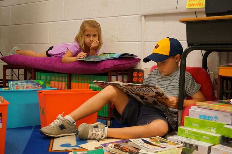 Photo of two elementary students with reading books