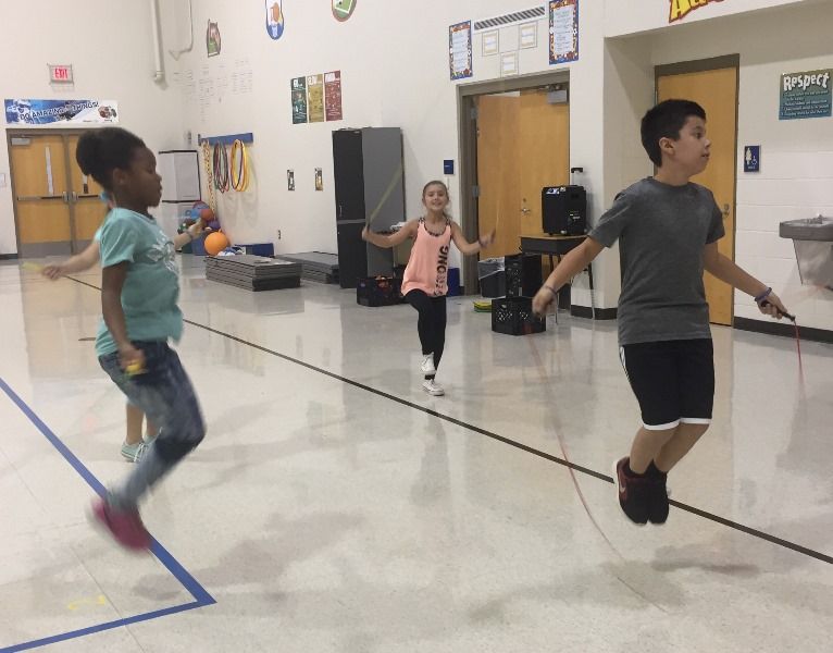 student in gym doing jump rope