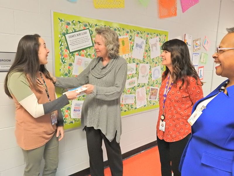 Sterling School Spanish teacher Liz VanDommelen (left) with school board members