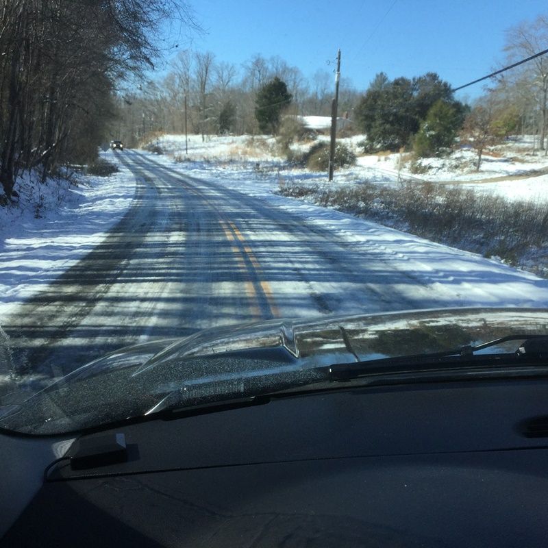 photo graph of icy roads from a driver's perspective
