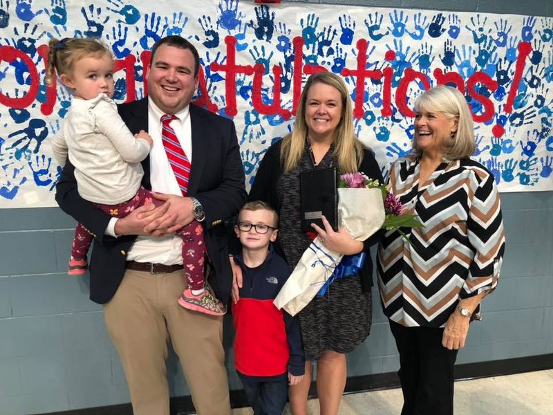 Stafford is pictured with her husband Todd, an Assistant Principal at Greer High School, their two children and her mother.