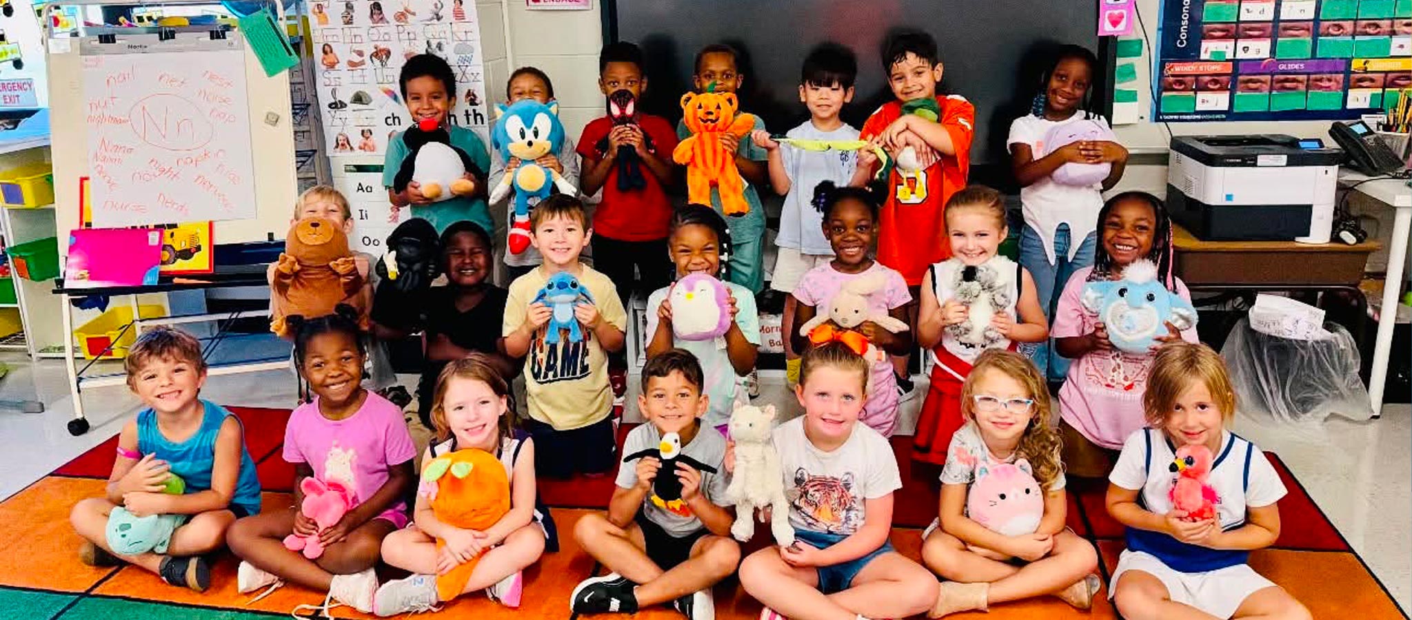 class of students holding stuffed animals