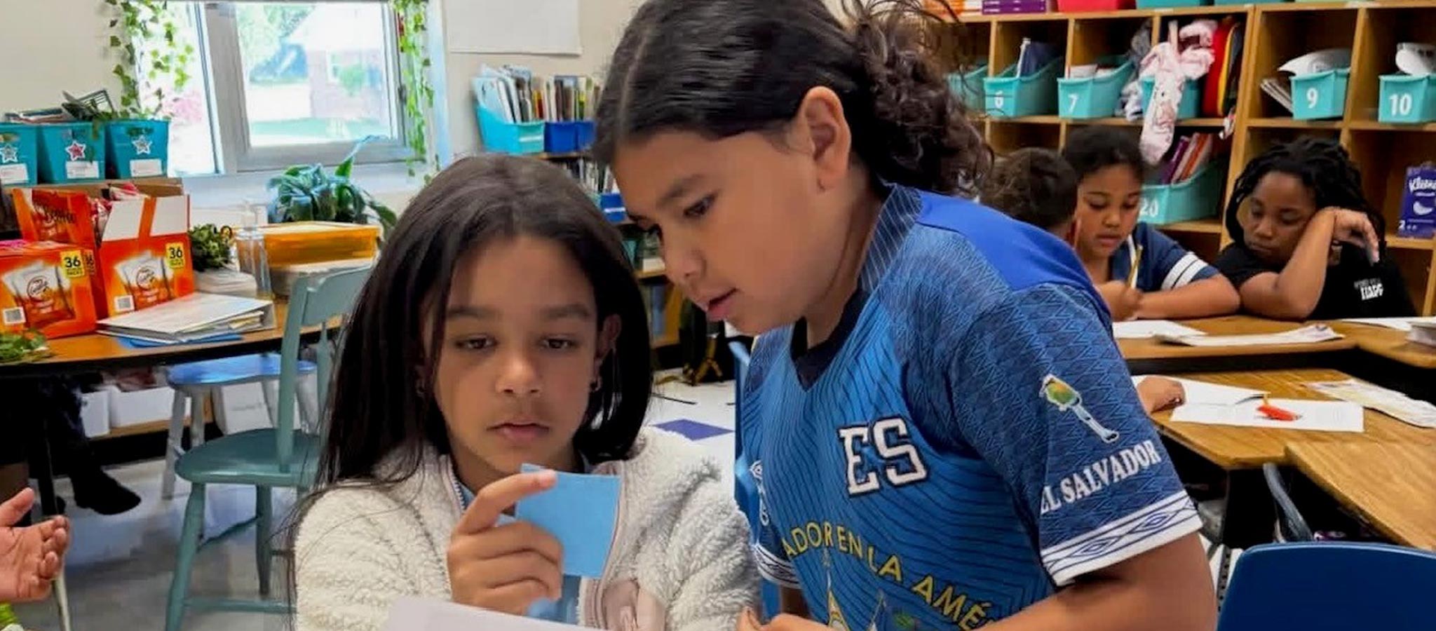2 Students working together looking at a piece of paper