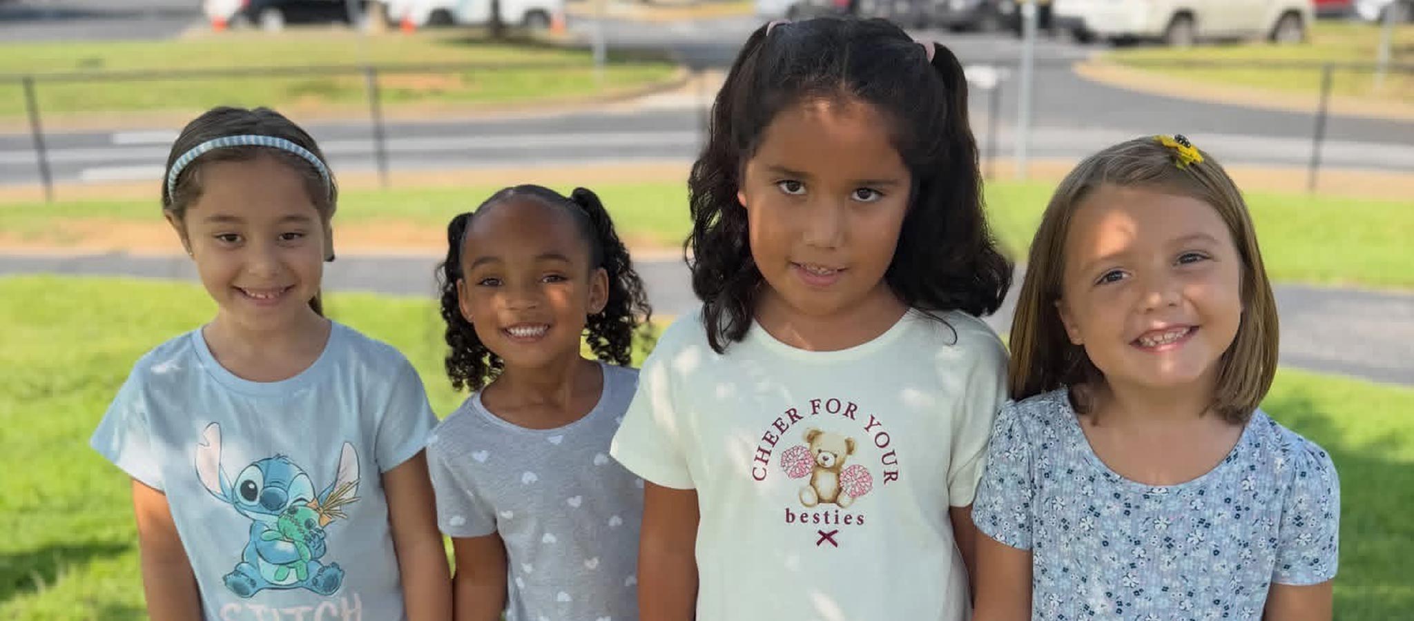 4 girls outside smiling