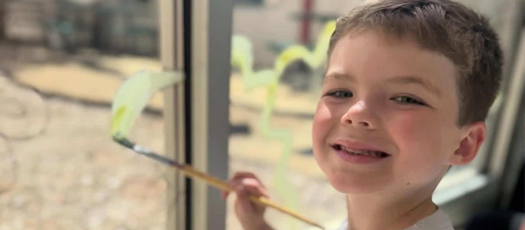 boy painting window