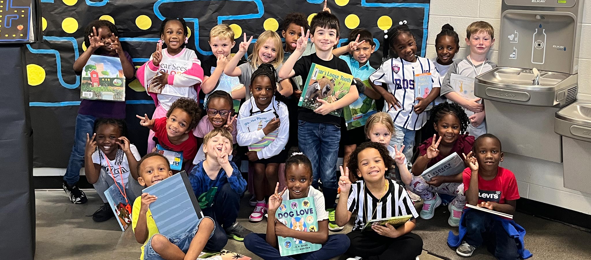Students holding up their books