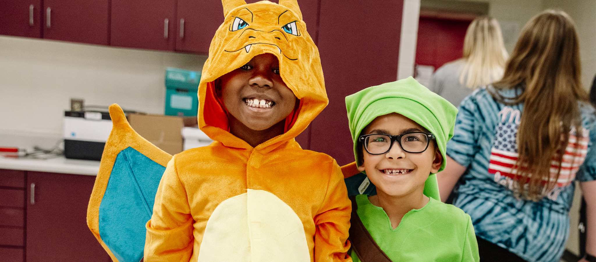 Two students posing together in costumes at Boo Night.