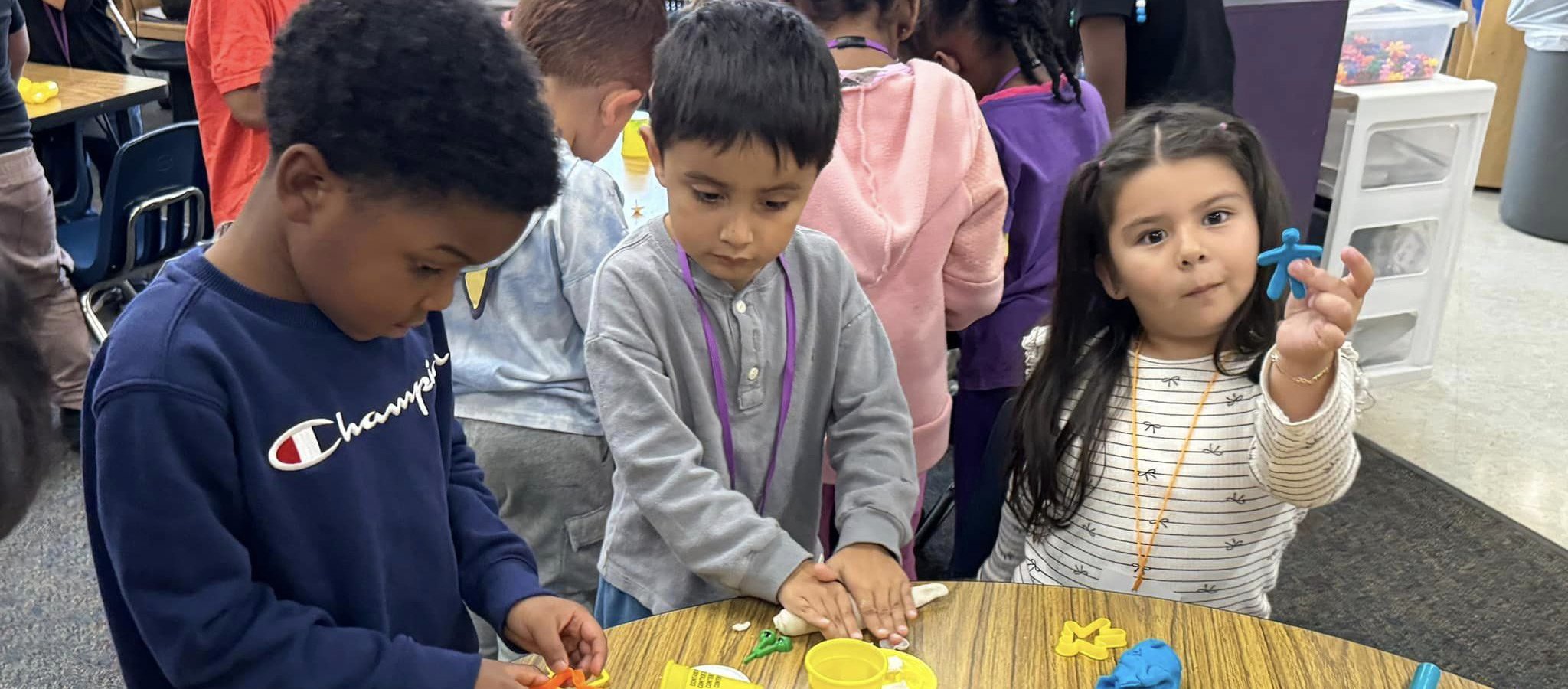 Students at Chandler Creek building with playdoh.