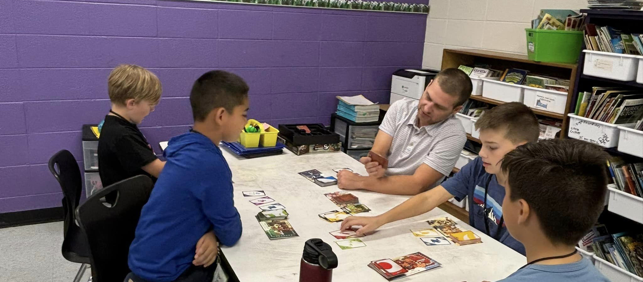 Students learning to play Uno in Board Games Club.