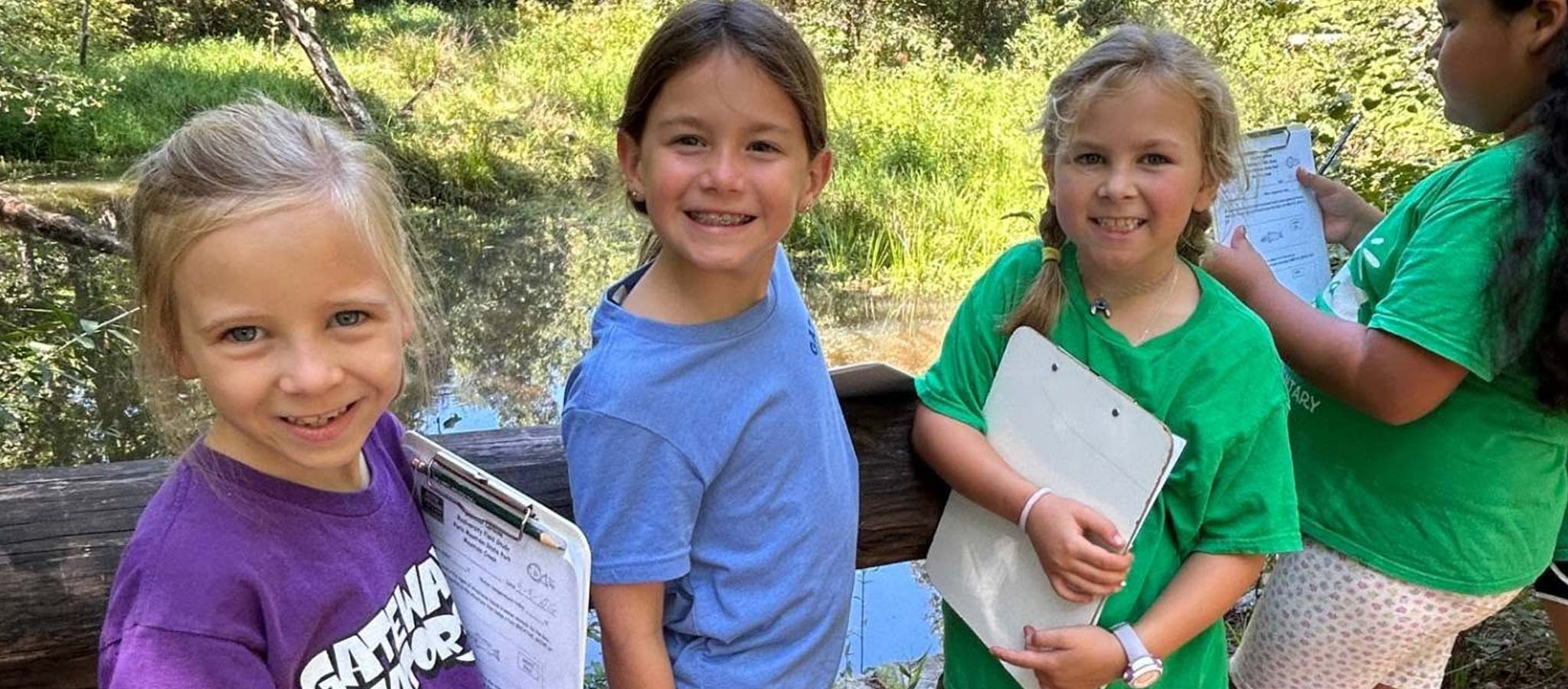 students outside with paper doing an activity