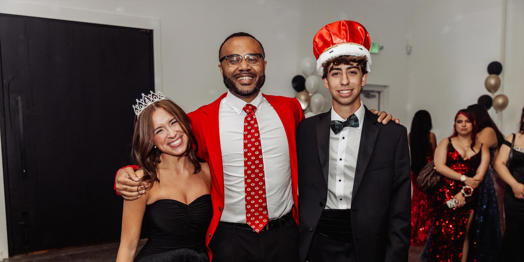 Mr. Hudson with the Prom King and Prom Queen