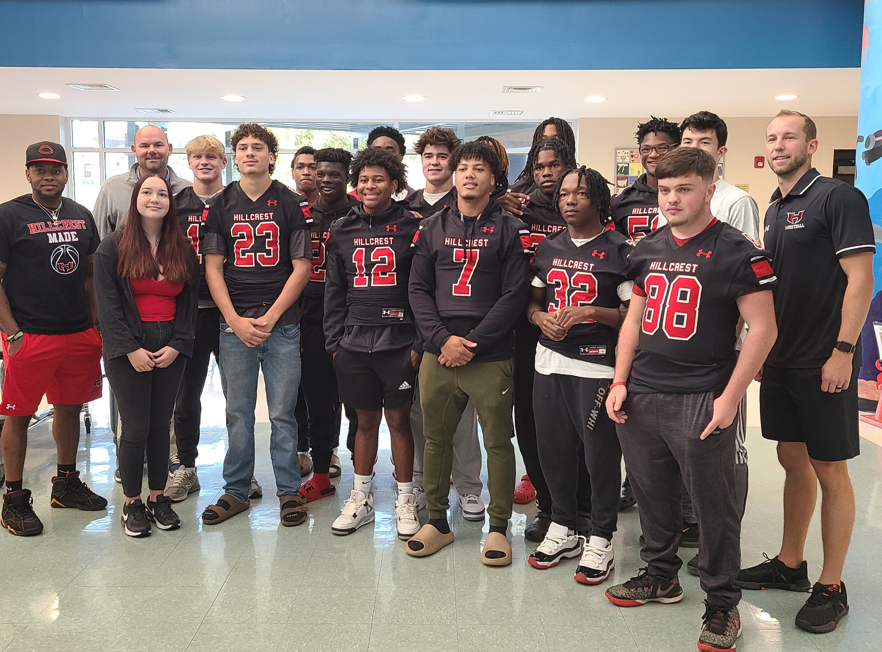 Image is a photo of Hillcrest athletes lined up together.