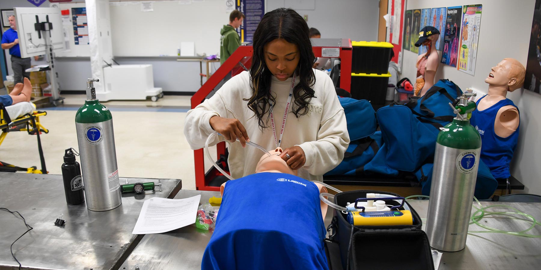 Medical student inserting a tube in a manikin