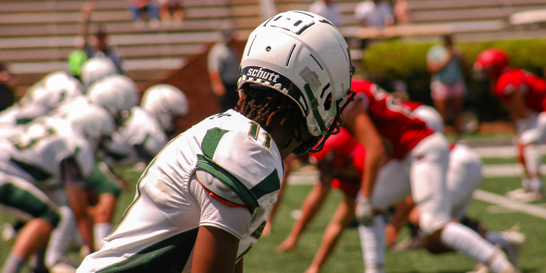 football receiver looking down the line of scrimmage during a play