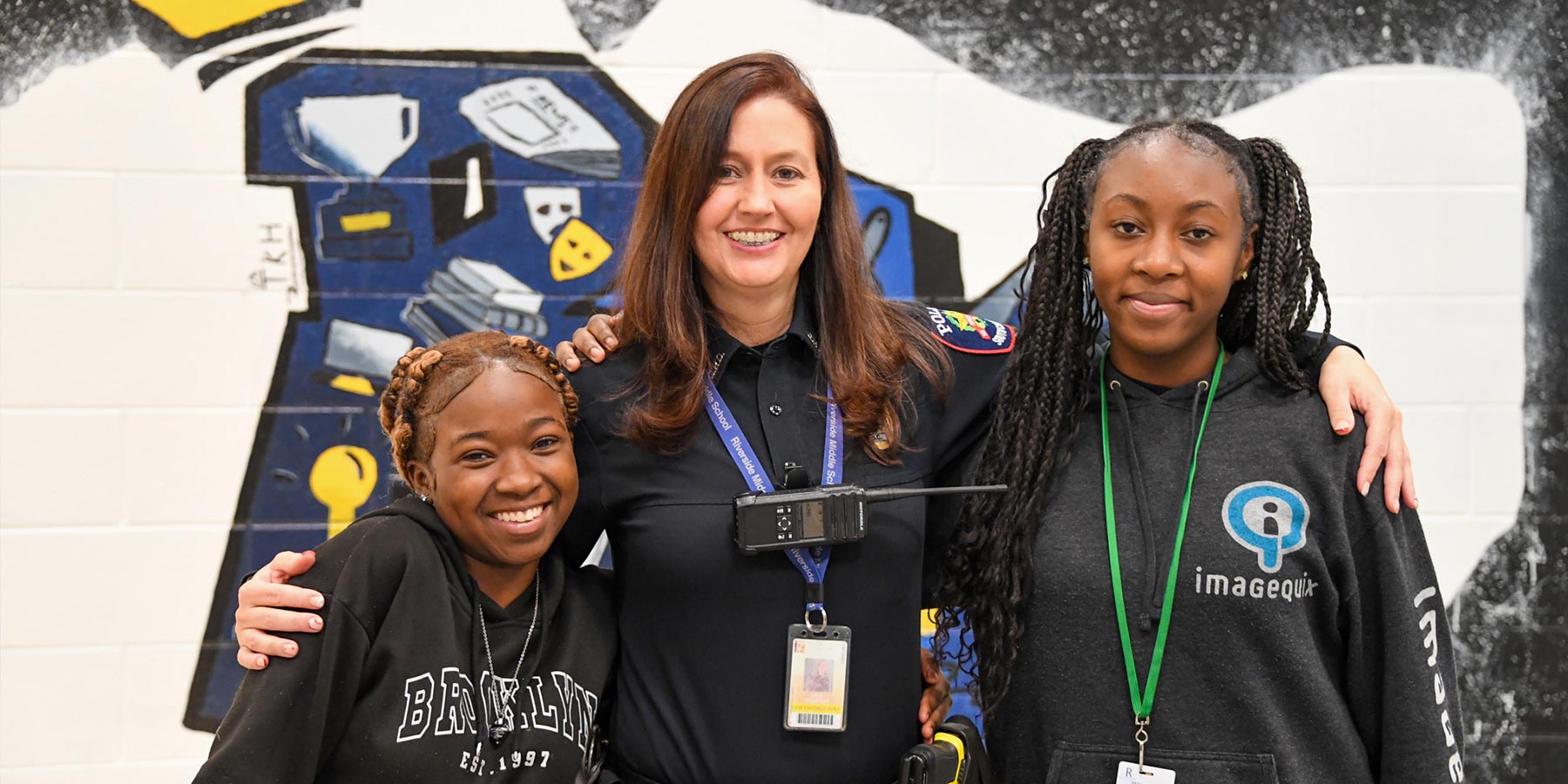 female teacher with two middle school female students