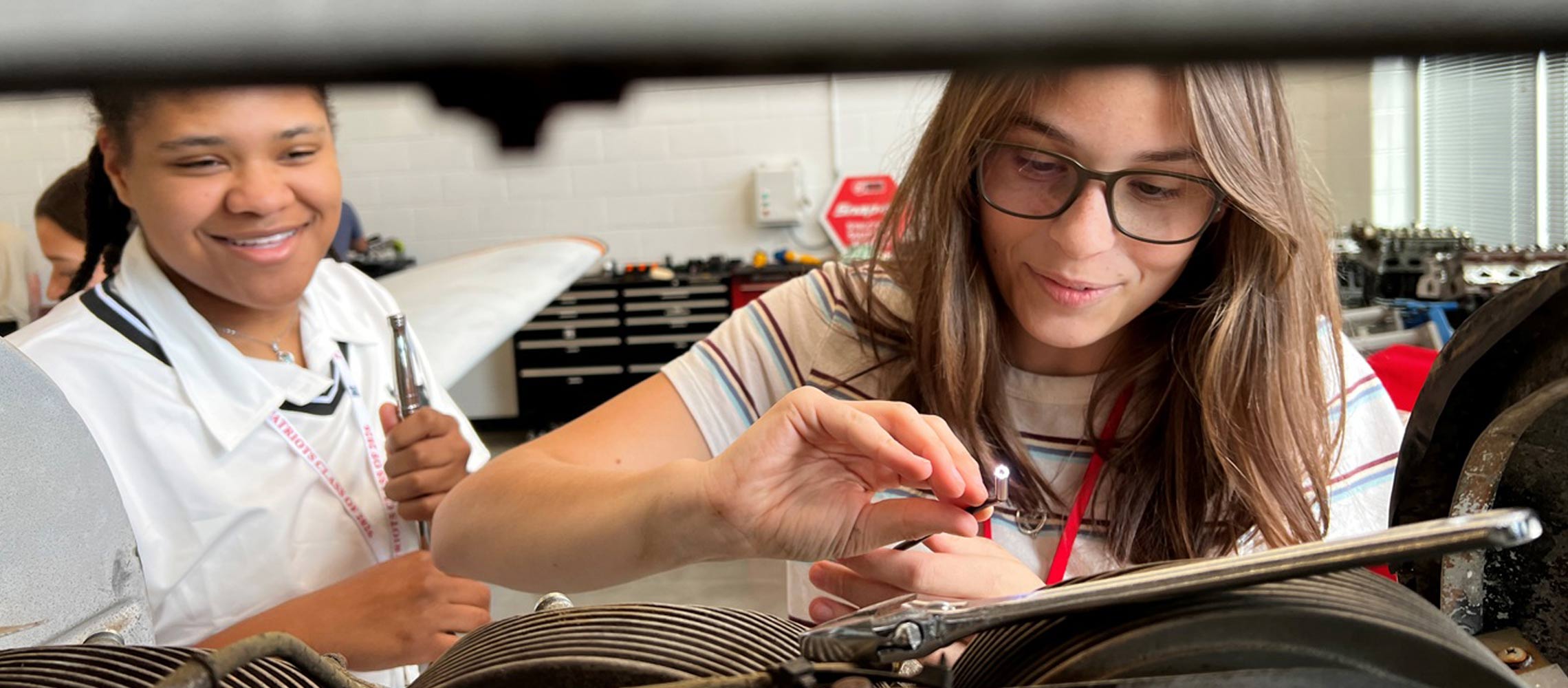 students doing airplane repair