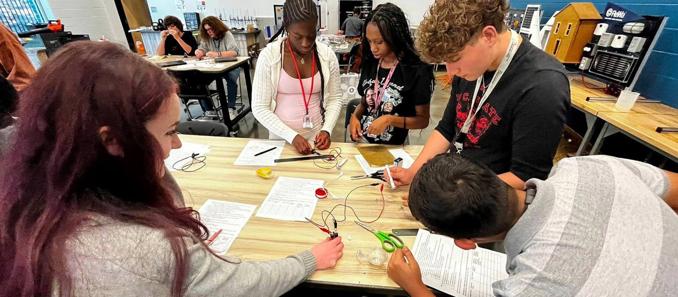 students working with electricity and currents