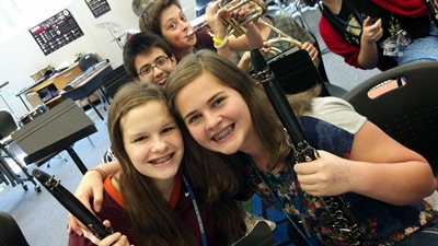 Photo of a few middle school children in a music classroom