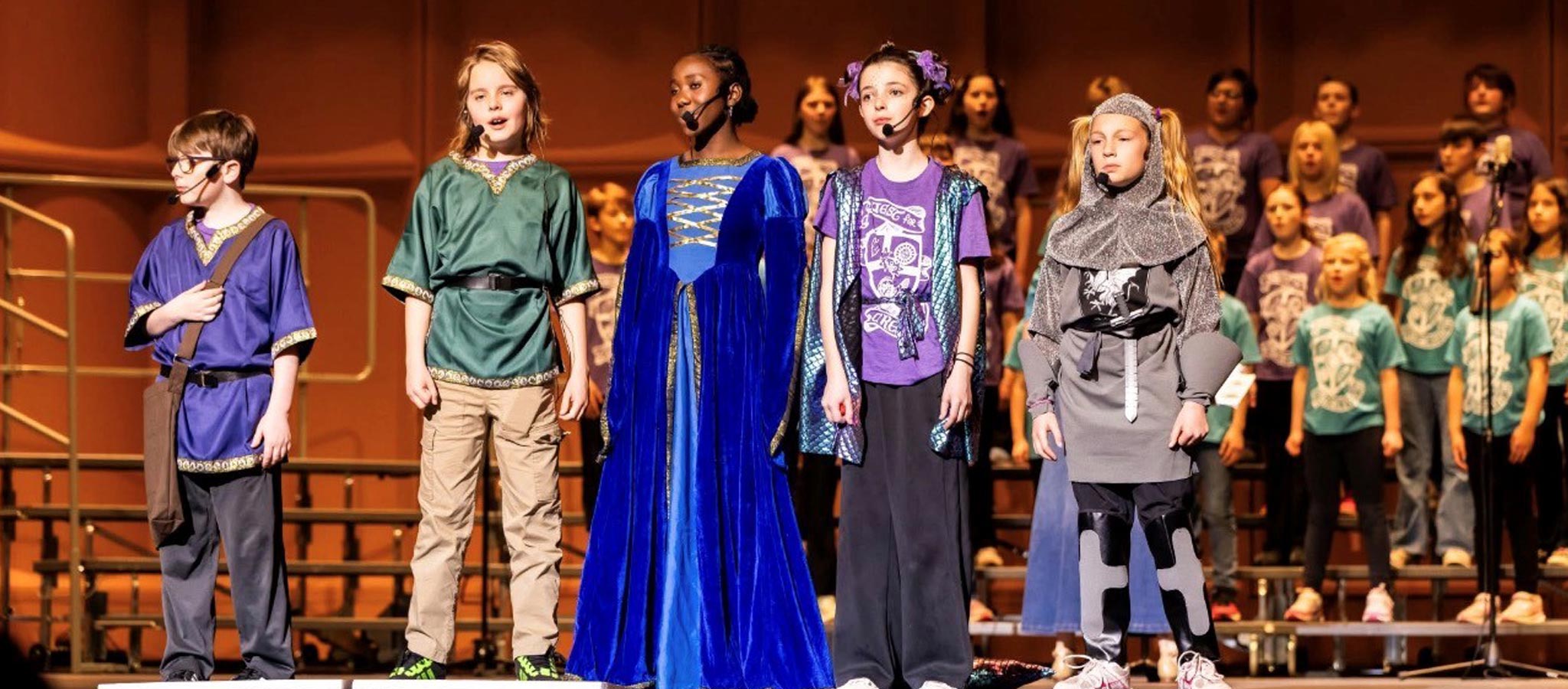 5 students singing with choir in the background