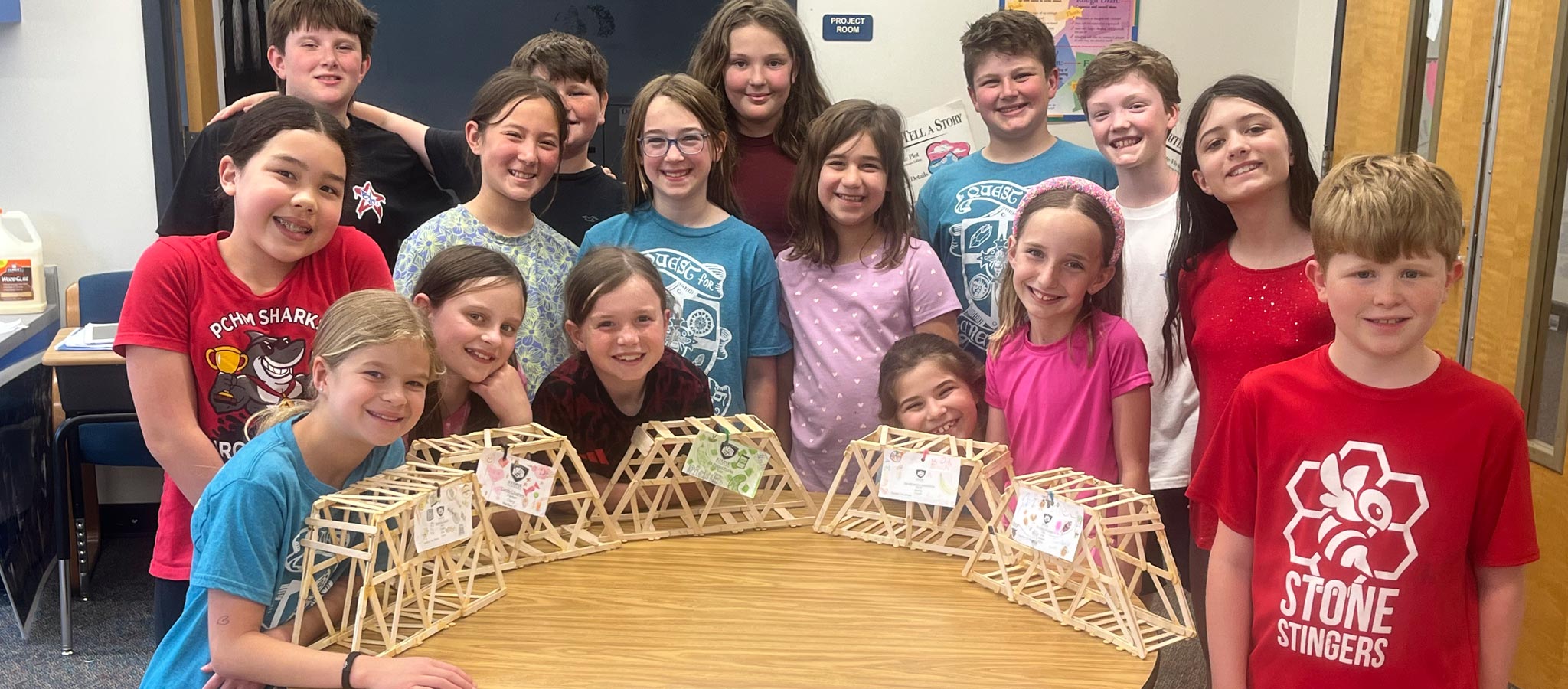 group of students with their projects made of wooden sticks