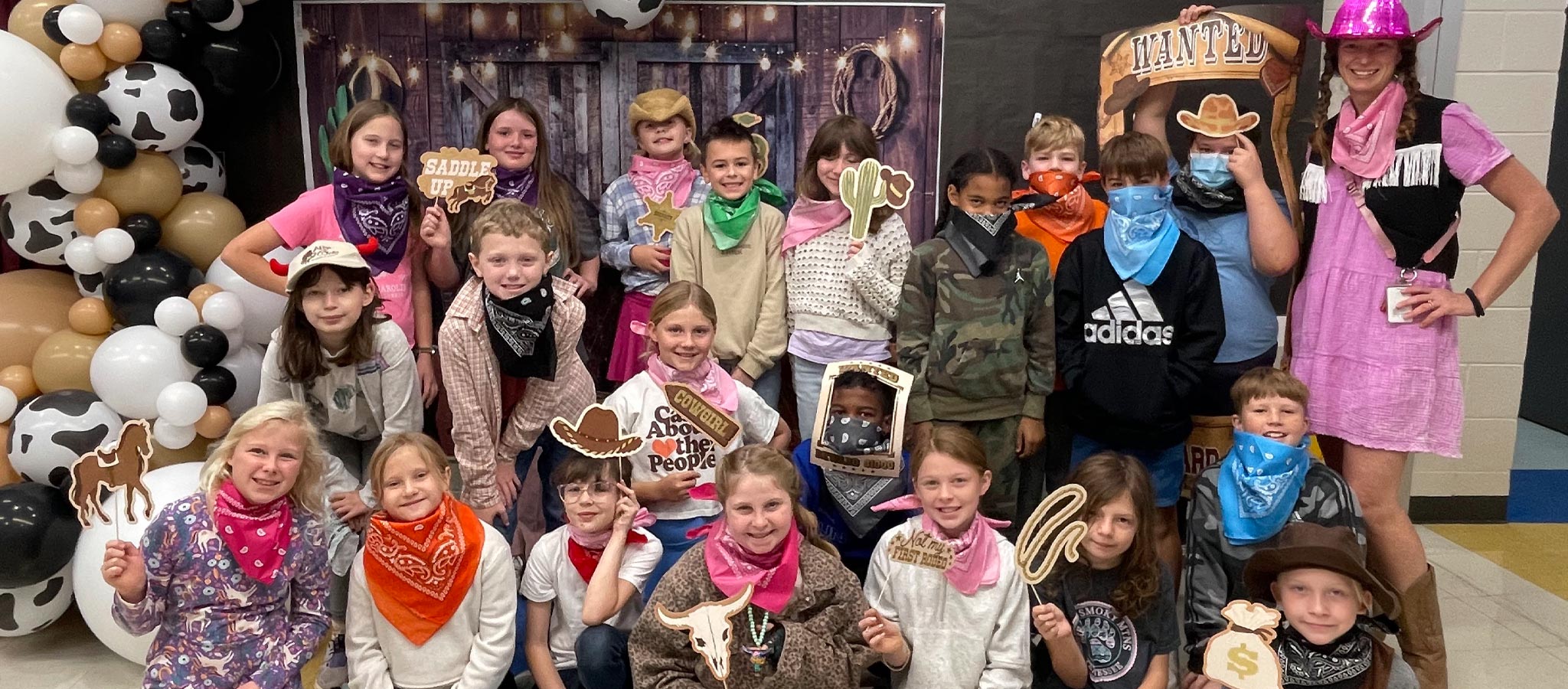 classroom students with teacher dressed in western attaire