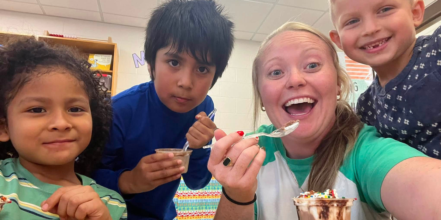 teacher with 3 students taking selfie eating ice cream